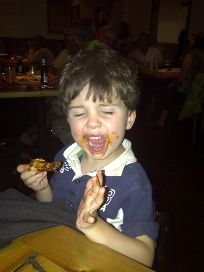 Enjoying his first chicken wings